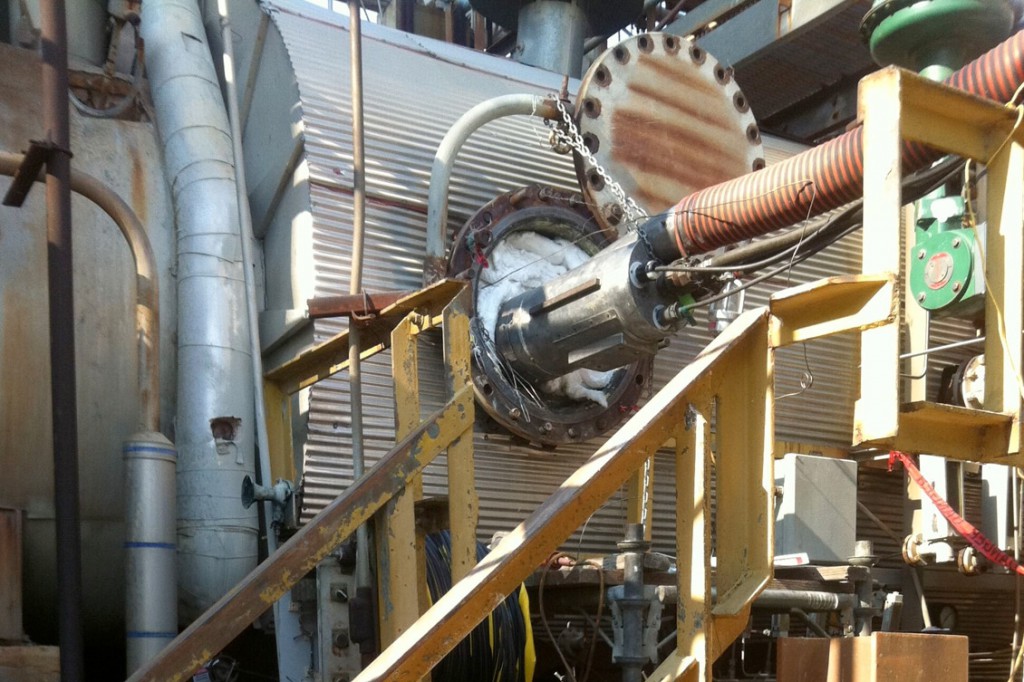 technician inspecting refinery furnace refractory lining